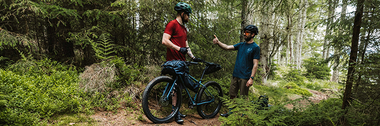 Genesis bike being ridden through the forest